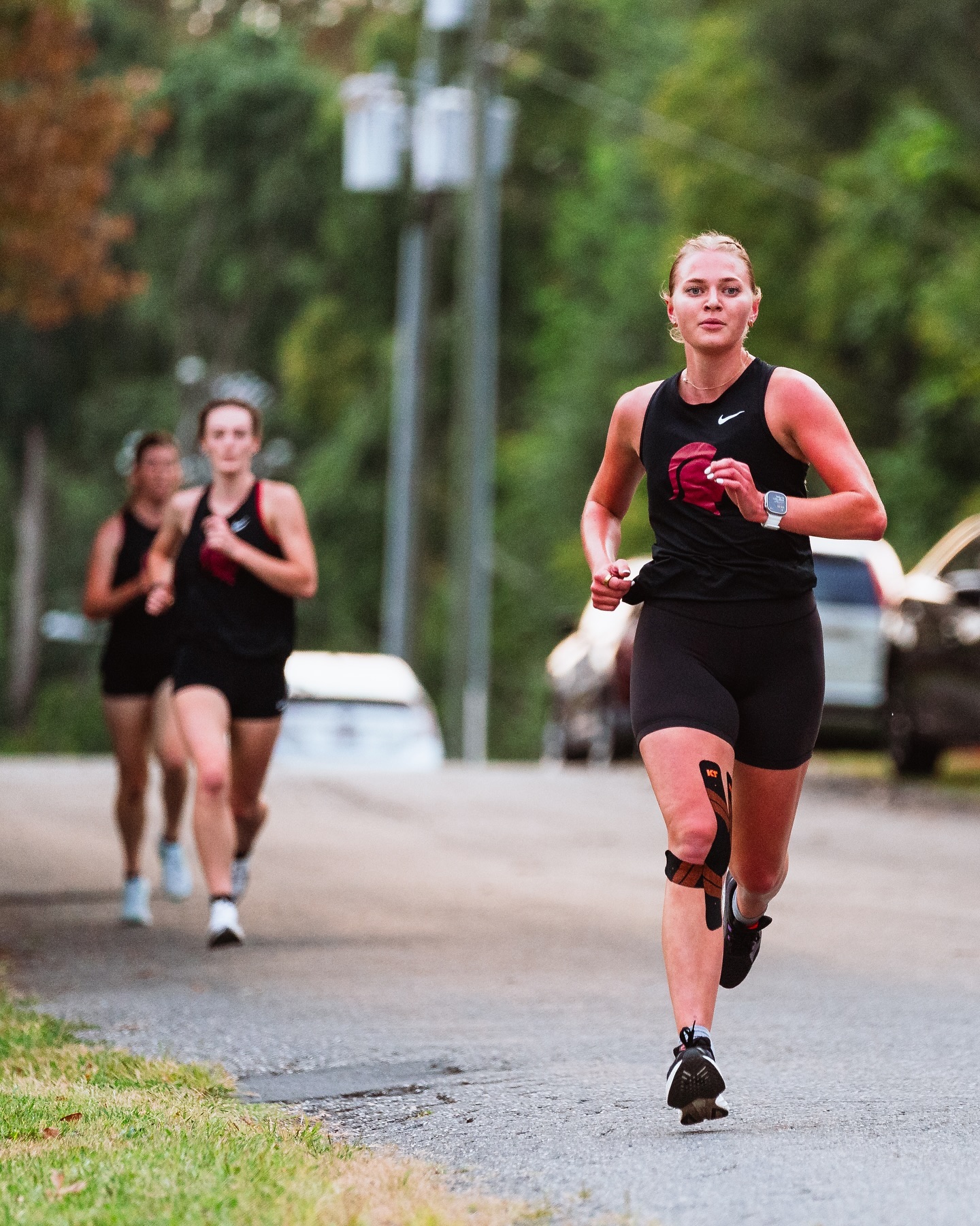 Three SVU runners compete in a race around campus.